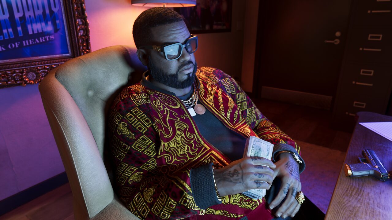 Boobie Ike seated in an office chair counting a stack of cash, a handgun on the desk beside him.