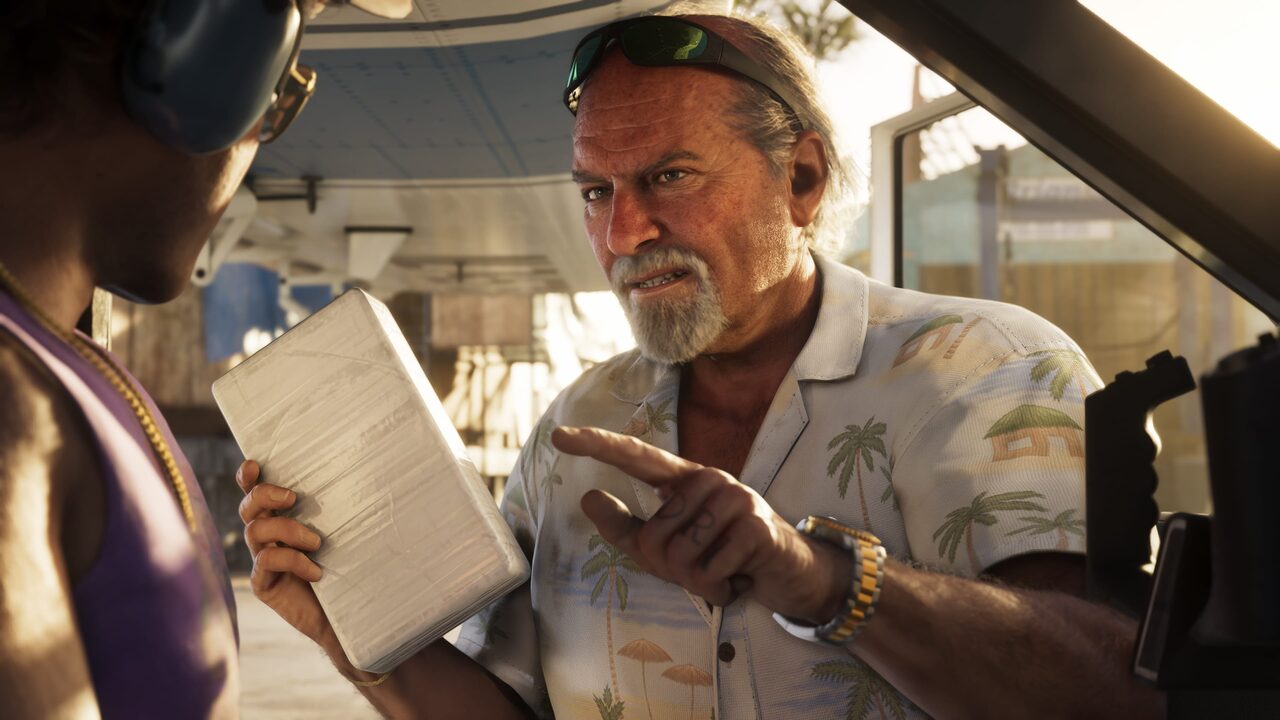 Brian Heder holding a wrapped package under a boat awning, gesturing while talking to another man.