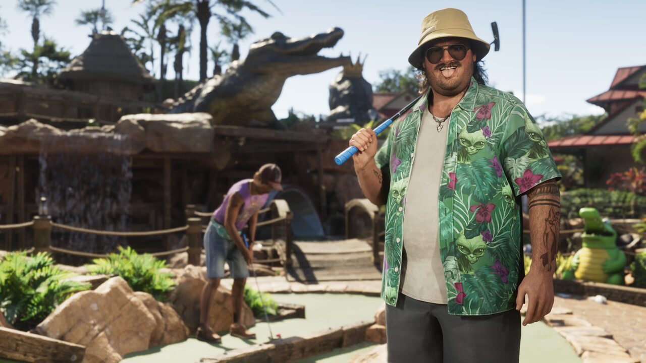 Cal Hampton at a mini-golf course, a putter over his shoulder, in a bucket hat and a leaf-print shirt.