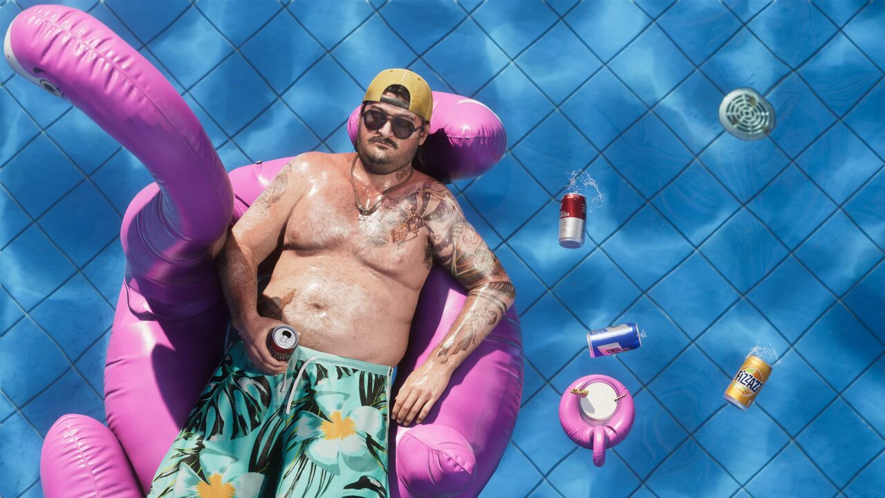 Cal Hampton floating in a pool on a pink flamingo raft, sunglasses on, drink cans scattered in the water around him.