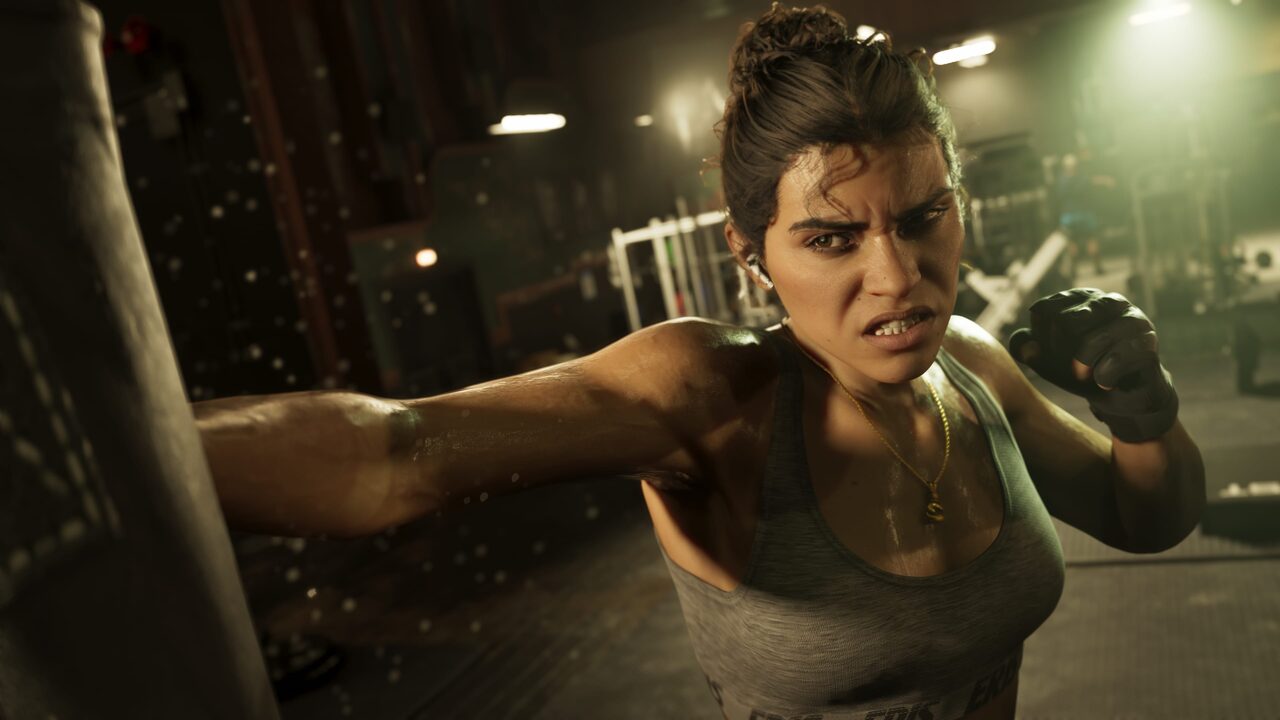 Lucia Caminos mid-punch against a heavy bag in a dimly lit gym, wearing training gloves.