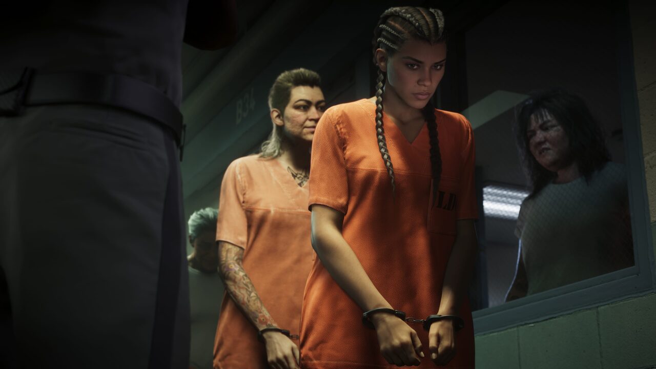 Lucia Caminos in handcuffs and an orange jumpsuit, led through a corridor with other inmates behind her.