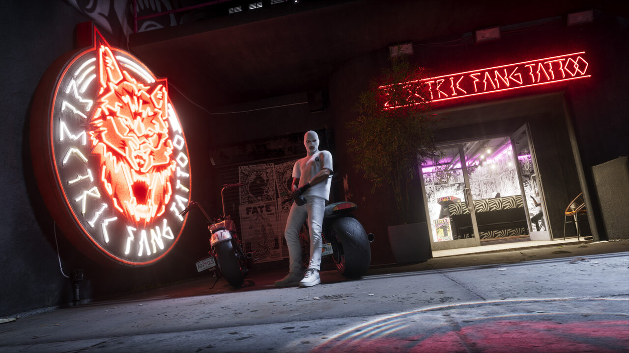 A masked figure leaning against a motorcycle outside Elektrik Fang Tattoo at night, a large neon wolf-head sign glowing red beside the doorway.