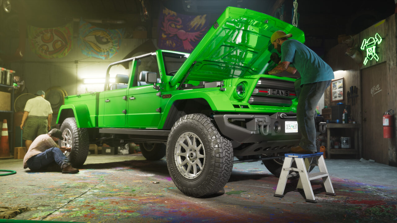 Mechanics working on a bright green Canis pickup in a paint-spattered garage, one leaning under the raised bonnet from a step stool.