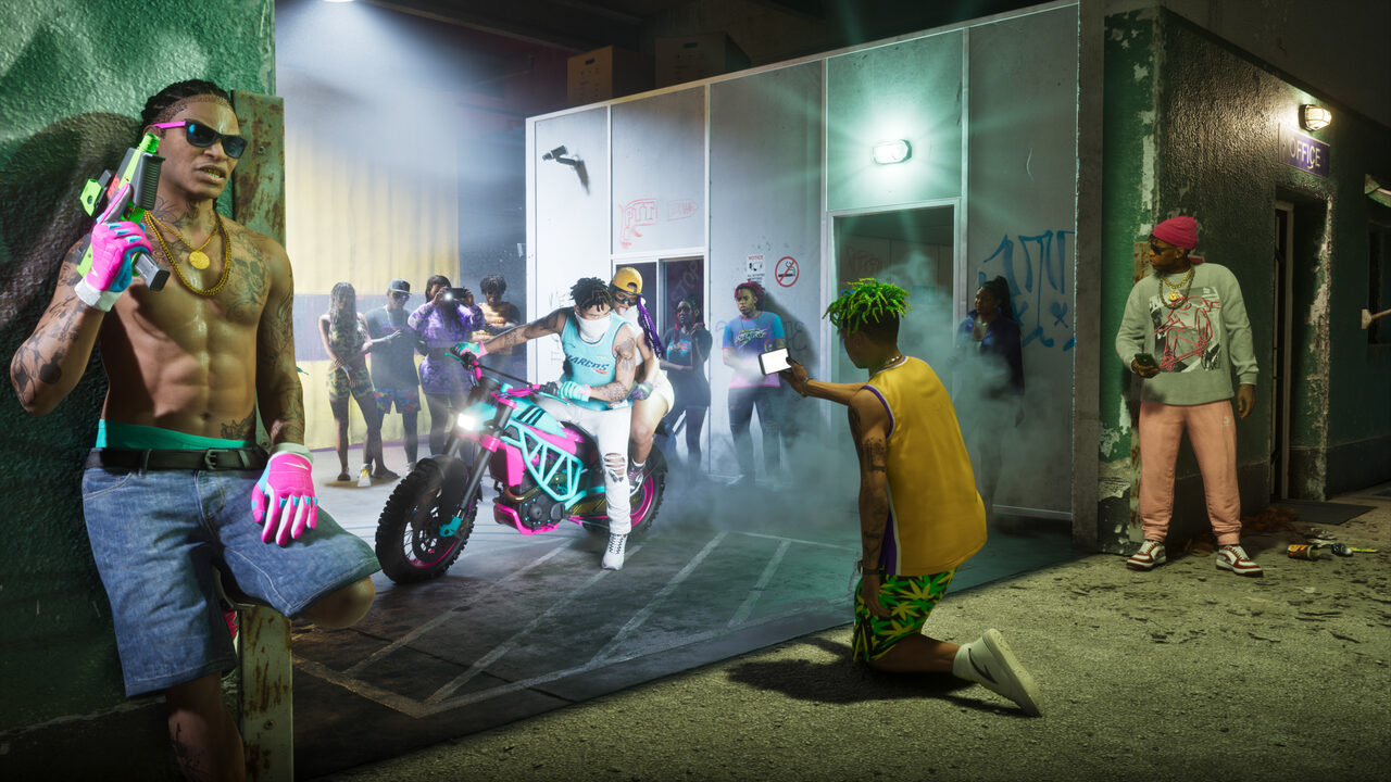 A crowd gathered outside a store at night, one man holding a pink and green pistol, a woman astride a pink and teal dirt bike, another man filming on a phone as smoke drifts across the lot.