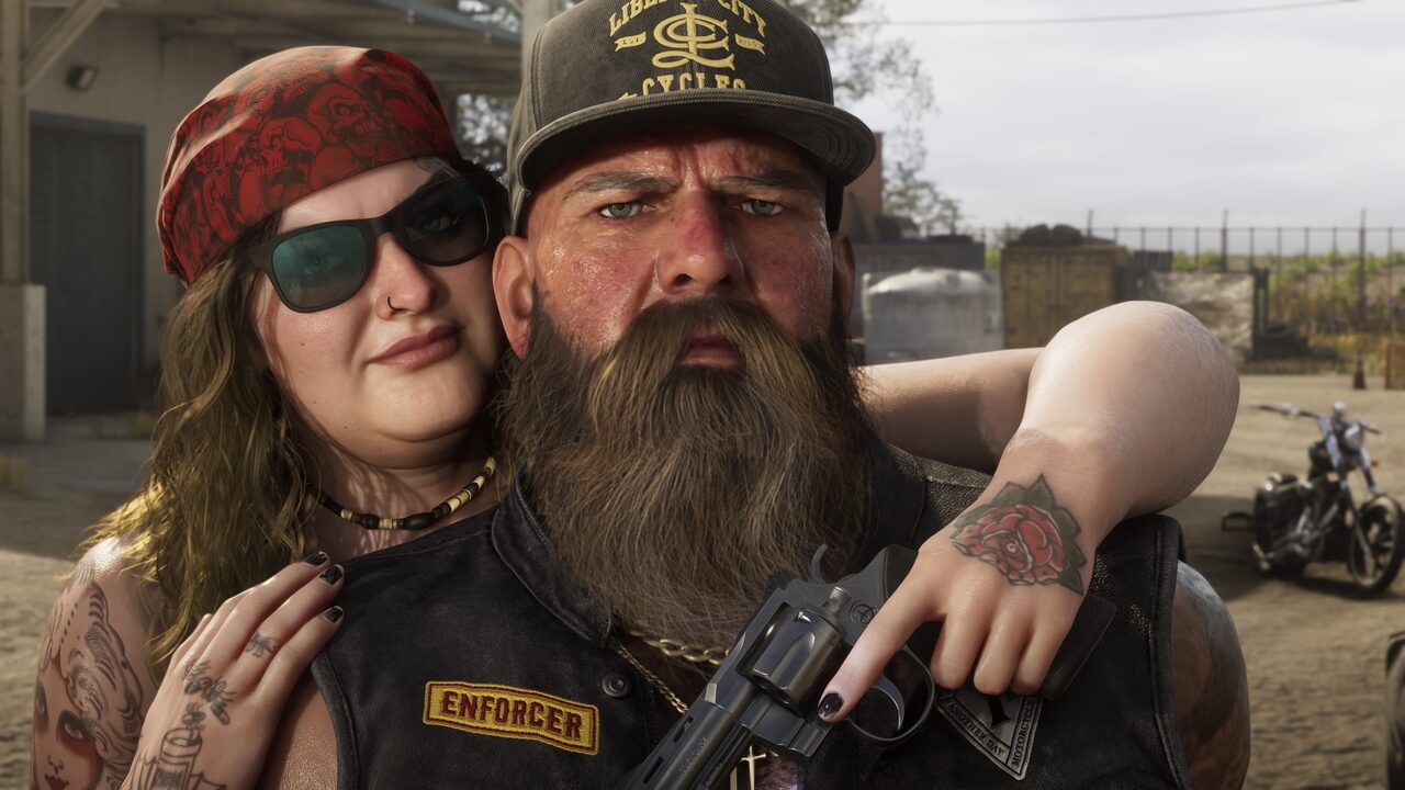Two bikers posed close to camera in a dirt lot, the man in a leather vest patched ENFORCER holding a revolver, a woman in a skull-print bandana with her arm around his shoulders.