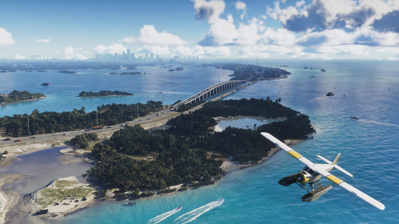 An aerial view along the Leonida Keys, a causeway linking low islands with a seaplane banking over turquoise water.