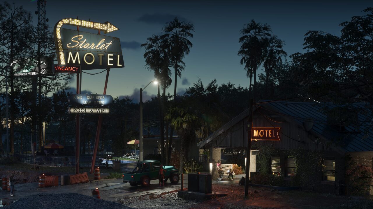 The lit sign of the Starlet Motel among palm trees at night in Port Gellhorn.