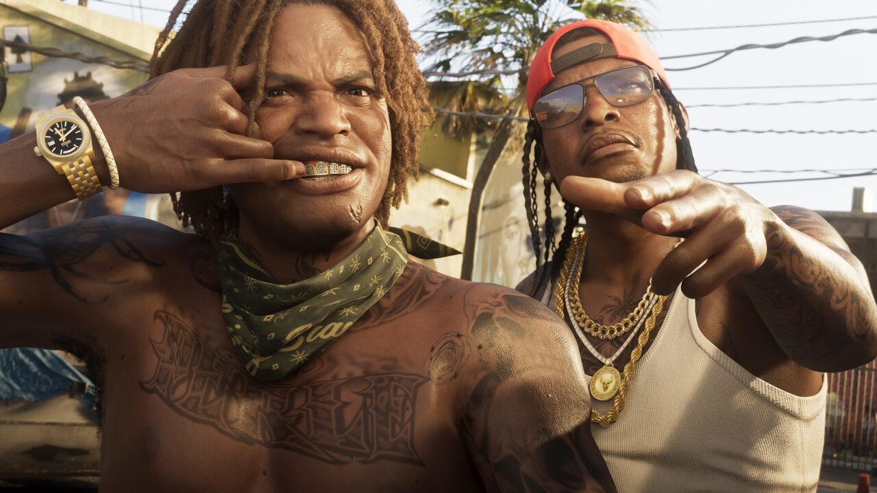Two men posing close to camera in a sunlit yard, one with a jewelled grill and a bandana round his neck, the other in sunglasses and gold chains pointing at the lens.